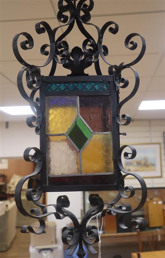 A wrought iron stained glass hall lantern